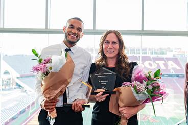 Williams and Arnett pose with their awards