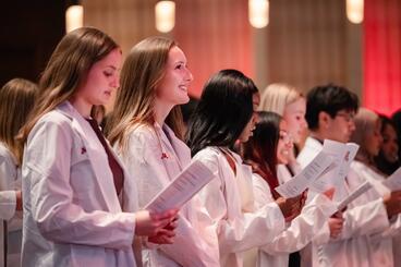 Learners recite their oath at the White Coat Ceremony