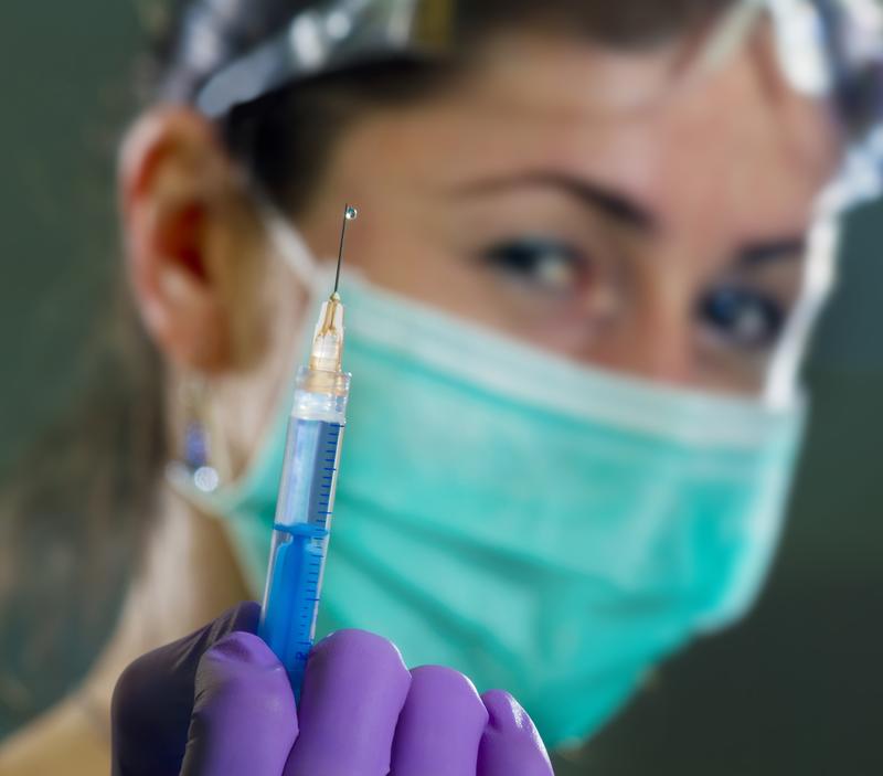 Dental professional with oral anesthetic injection