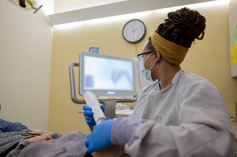 An Orofacial Pain resident works with a patient