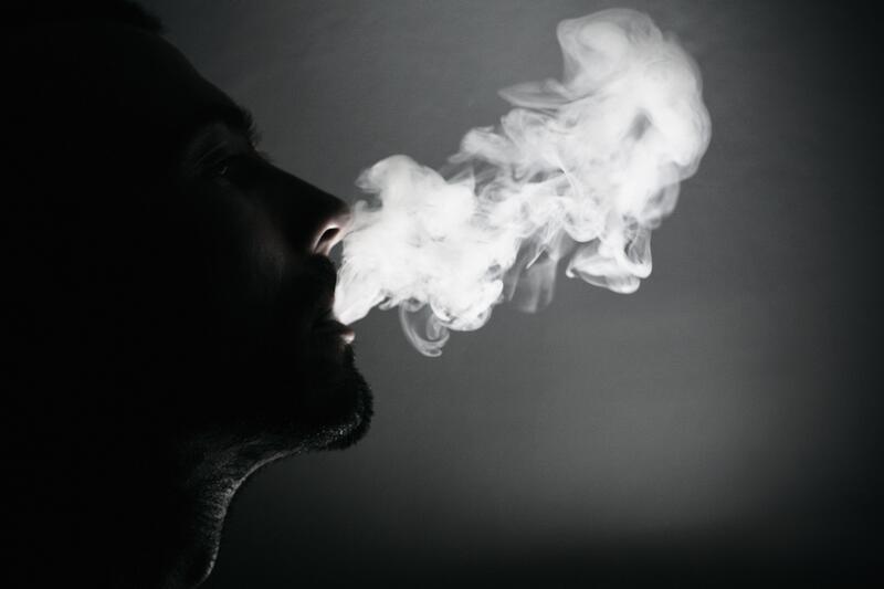 individual blowing smoke