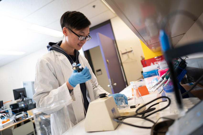 A student works with a pipette in a lab