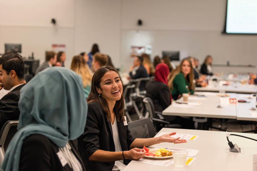 Two learners sit at a table and talk