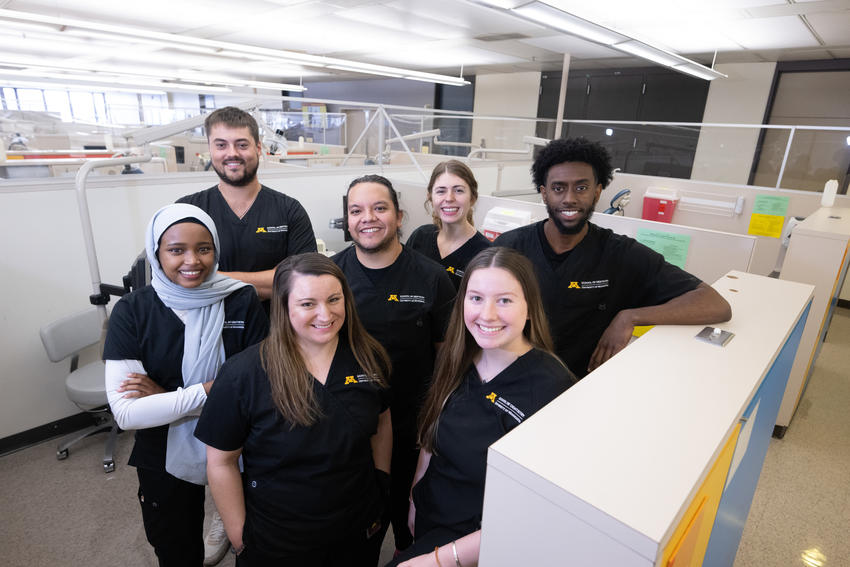 Dental therapy students standing together smiling for picture.