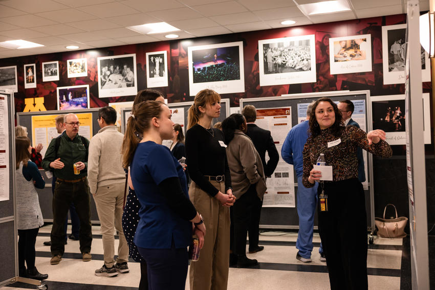 Sarah Aitken shares her research poster with attendees