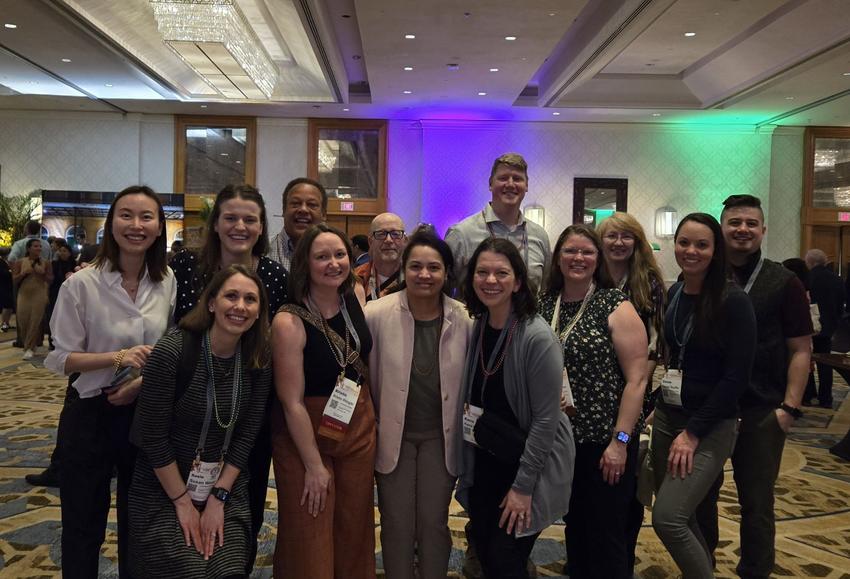 Faculty and students pose for a photo at ADEA