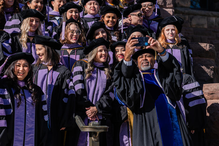 Dean Mays takes a selfie with a group of DDS graduates