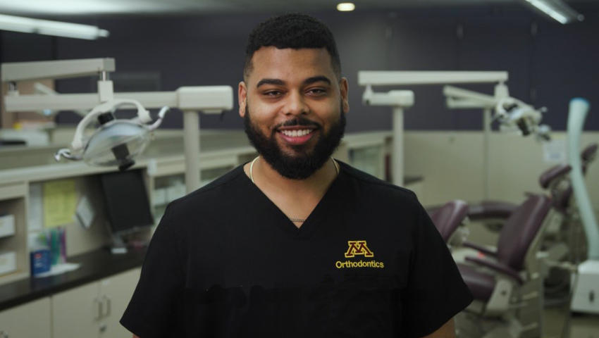 Kaimen Obeng smiles at the camera in the Orthodontics clinic