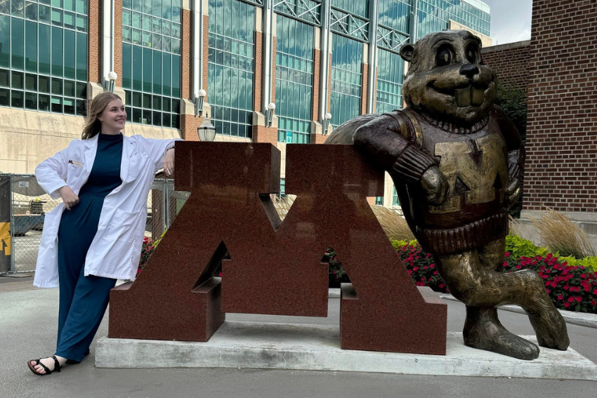 Megan Wass with Goldy Statue