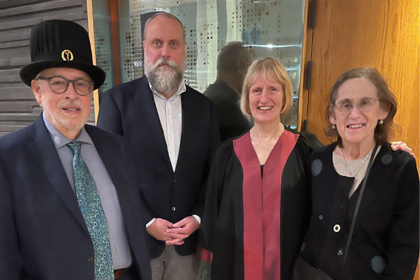 Group picture of 4 people smiling.