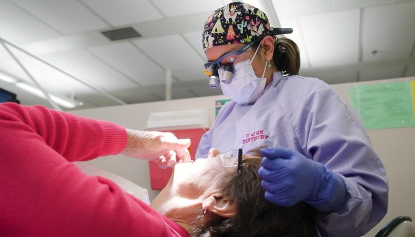 Jessie Walsh treats a patient in the clinic
