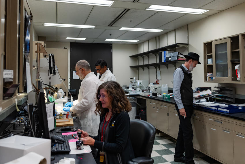 4 individuals working in oral pathology lab.