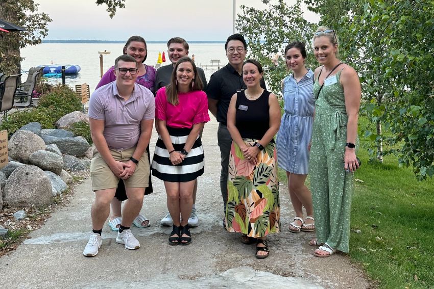 Students and faculty pose for a photo after an Outreach dinner