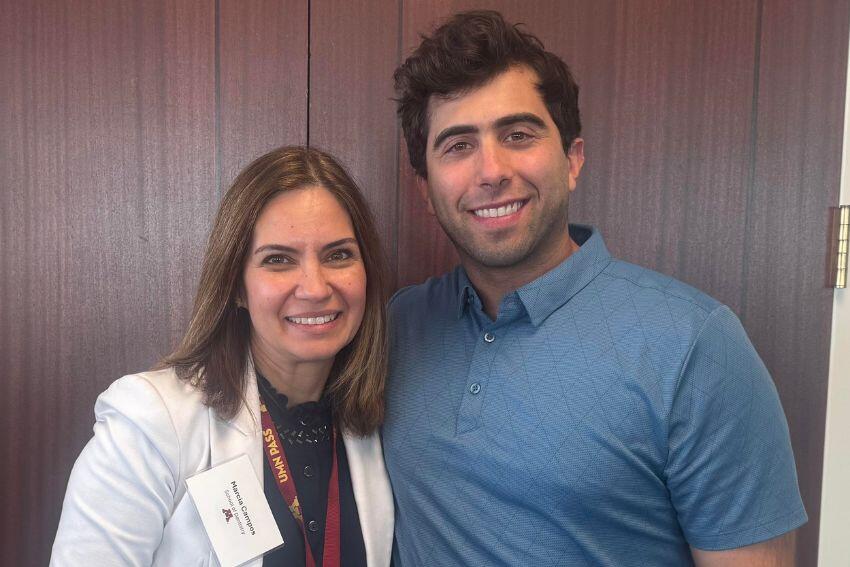 Marcia Campos and Michael Korleski pose together in front of a door