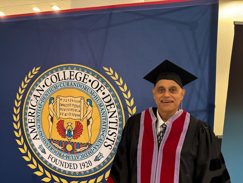 Petker poses with the American College of Dentists logo