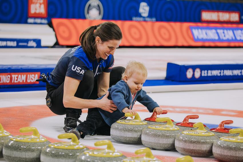 Peterson and her son play with Curling rocks 