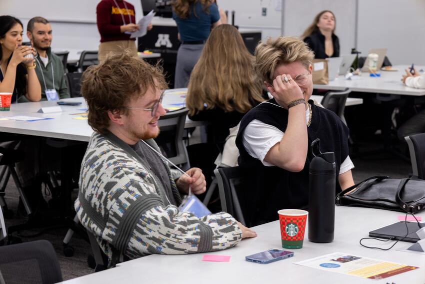 Two dentistry students talk and smile at the CHIP conference