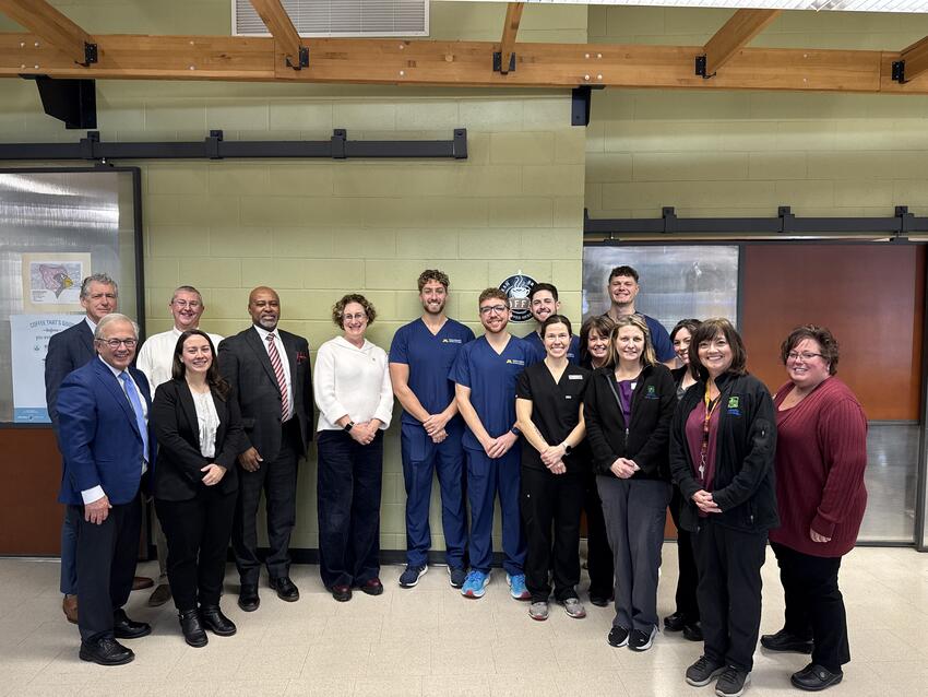 A group of students and faculty pose with Rebecca Cunningham and Dean Mays