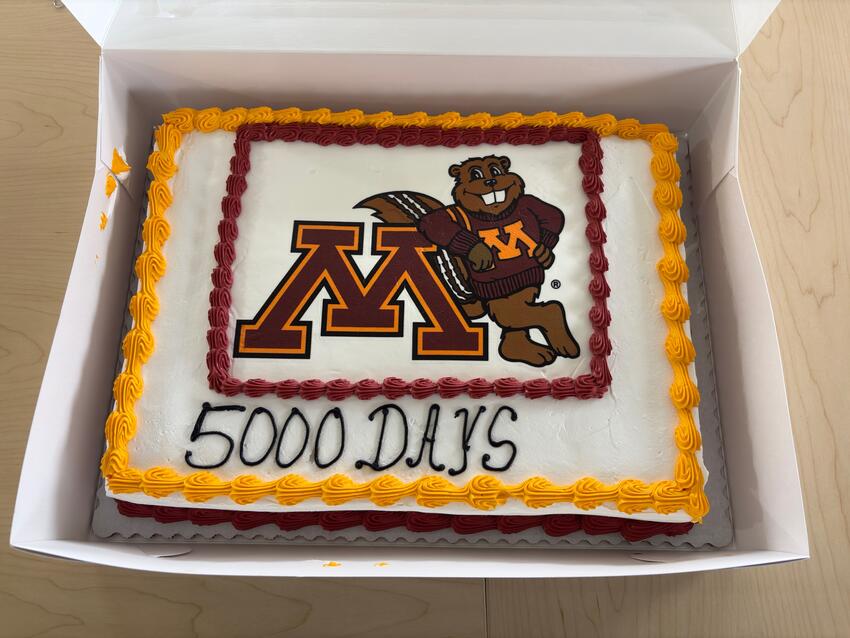 A sheet cake includes the University of Minnesota logo and says "5000 days"