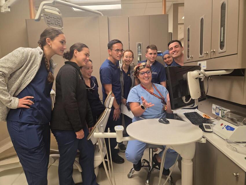Uppgaard presents to a group of DDS students in a clinic space