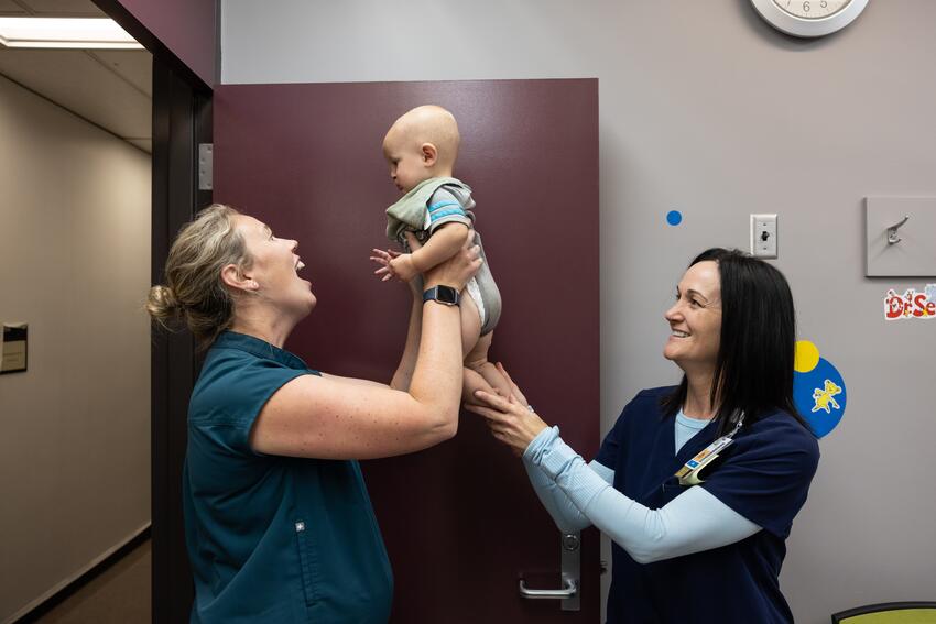 McBeain and Olesen play with an infant patient