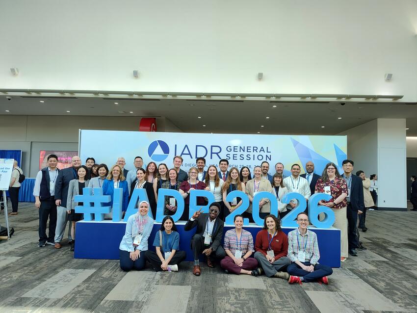 School of Dentistry attendees pose at the IADR sign