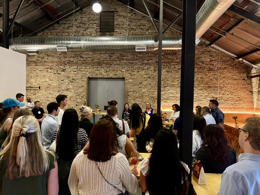 Attendees of the SAID conference listen to speakers at a networking event