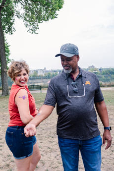 Dean Mays and Maureen Lovestrand pose with airbrushed tattoos