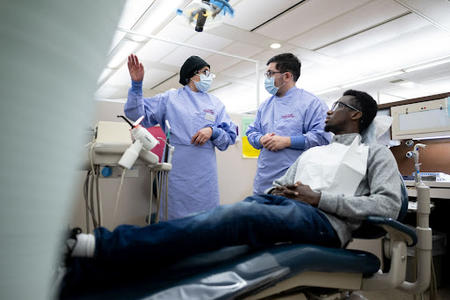Adjunct Alumni with a patient