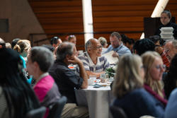 Retreat attendees talk and smile at their tables