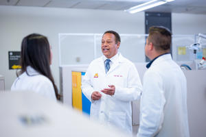 Karl Self speaks with colleagues