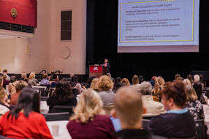 Tamanna Tiwari speaks to a large crowd at Research Day