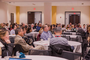 Attendees listen to presentations at Research Day