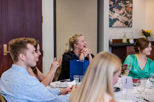 Learners smile as they listen to a presentation