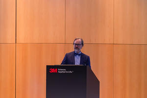 Paul Klaiber speaks behind a podium at 3M