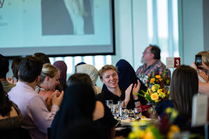Attendees smile and applaud