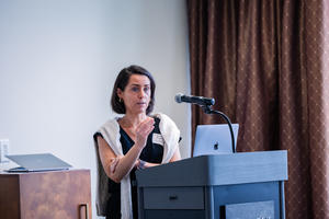 Brugman presents her keynote address from a podium